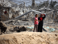 Palestinians inspect the damage at the site of Israeli strikes on a makeshift displacement camp in Mawasi Khan Yunis in the Gaza Strip on Se...