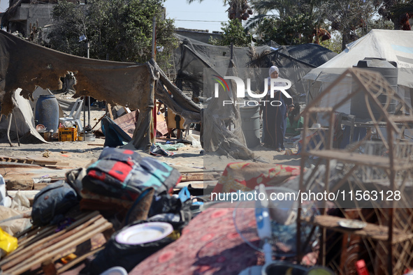 Palestinians inspect the damage at the site of Israeli strikes on a makeshift displacement camp in Mawasi Khan Yunis in the Gaza Strip on Se...