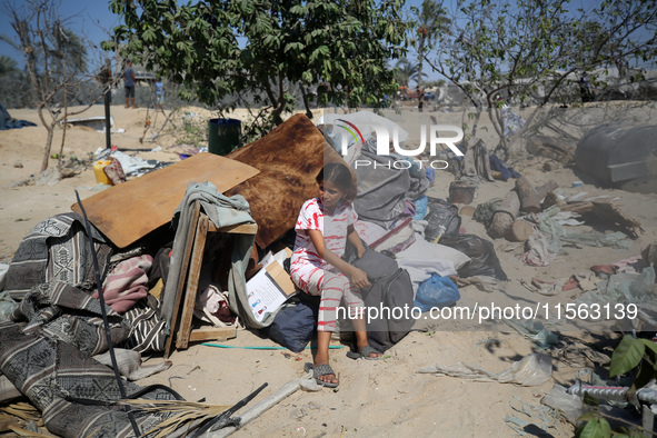 A Palestinian youth inspects the damage at the site of Israeli strikes on a makeshift displacement camp in Mawasi Khan Yunis in the Gaza Str...