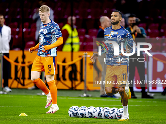 Netherlands forward Cody Gakpo and Netherlands midfielder Jerdy Schouten during the match between the Netherlands and Germany at the Johan C...