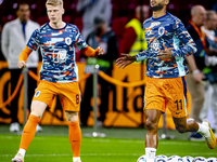 Netherlands forward Cody Gakpo and Netherlands midfielder Jerdy Schouten during the match between the Netherlands and Germany at the Johan C...