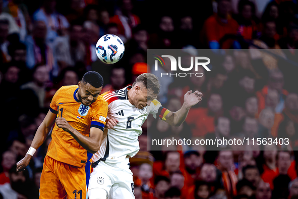 Netherlands forward Cody Gakpo and Germany midfielder Joshua Kimmich during the match between the Netherlands and Germany at the Johan Cruij...