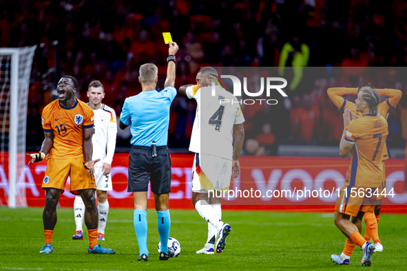 Germany defender Jonathan Tah receives a yellow card during the match between the Netherlands and Germany at the Johan Cruijff ArenA for the...