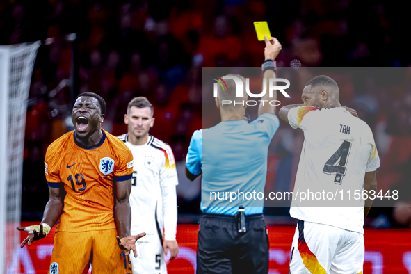 Germany defender Jonathan Tah receives a yellow card during the match between the Netherlands and Germany at the Johan Cruijff ArenA for the...