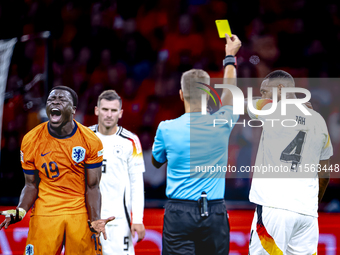 Germany defender Jonathan Tah receives a yellow card during the match between the Netherlands and Germany at the Johan Cruijff ArenA for the...