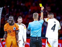 Germany defender Jonathan Tah receives a yellow card during the match between the Netherlands and Germany at the Johan Cruijff ArenA for the...