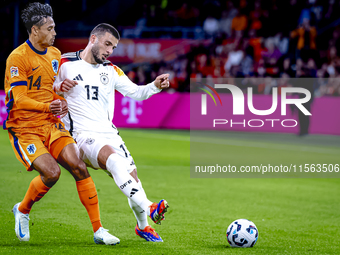 Netherlands midfielder Tijani Reijnders and Germany forward Deniz Undav during the match between the Netherlands and Germany at the Johan Cr...