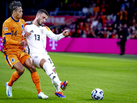 Netherlands midfielder Tijani Reijnders and Germany forward Deniz Undav during the match between the Netherlands and Germany at the Johan Cr...