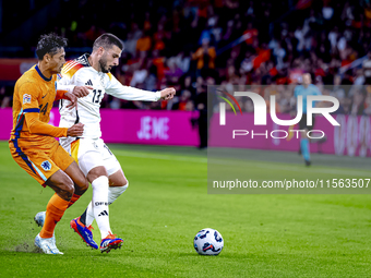 Netherlands midfielder Tijani Reijnders and Germany forward Deniz Undav during the match between the Netherlands and Germany at the Johan Cr...