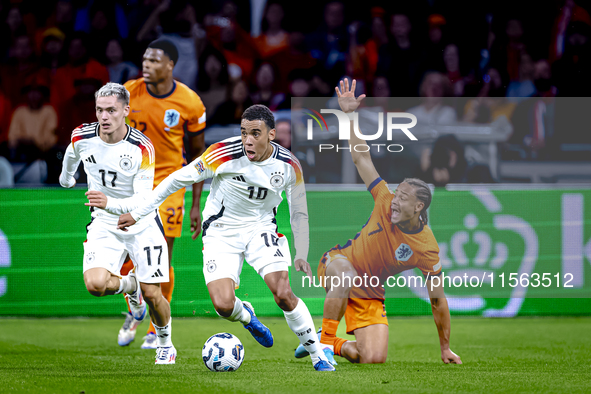 Germany midfielder Jamal Musiala and Netherlands midfielder Xavi Simons during the match between the Netherlands and Germany at the Johan Cr...