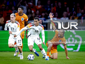 Germany midfielder Jamal Musiala and Netherlands midfielder Xavi Simons during the match between the Netherlands and Germany at the Johan Cr...