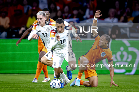 Germany midfielder Jamal Musiala and Netherlands midfielder Xavi Simons during the match between the Netherlands and Germany at the Johan Cr...