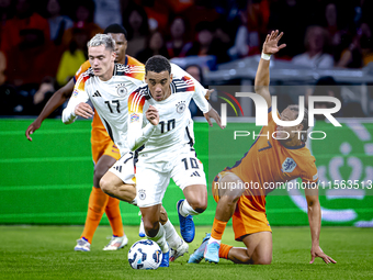 Germany midfielder Jamal Musiala and Netherlands midfielder Xavi Simons during the match between the Netherlands and Germany at the Johan Cr...