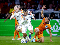 Germany midfielder Jamal Musiala and Netherlands midfielder Xavi Simons during the match between the Netherlands and Germany at the Johan Cr...