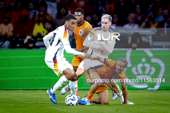 Germany midfielder Jamal Musiala and Netherlands midfielder Xavi Simons during the match between the Netherlands and Germany at the Johan Cr...