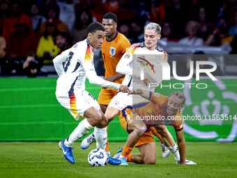 Germany midfielder Jamal Musiala and Netherlands midfielder Xavi Simons during the match between the Netherlands and Germany at the Johan Cr...