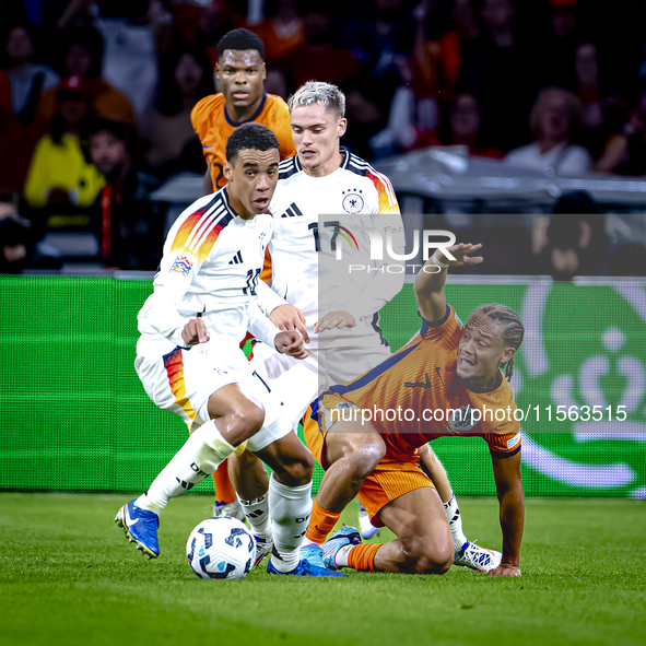 Germany midfielder Jamal Musiala and Netherlands midfielder Xavi Simons during the match between the Netherlands and Germany at the Johan Cr...