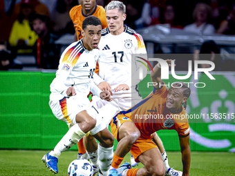 Germany midfielder Jamal Musiala and Netherlands midfielder Xavi Simons during the match between the Netherlands and Germany at the Johan Cr...