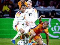 Germany midfielder Jamal Musiala and Netherlands midfielder Xavi Simons during the match between the Netherlands and Germany at the Johan Cr...