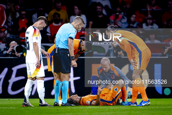 Netherlands defender Nathan Ake gets injured during the match between the Netherlands and Germany at the Johan Cruijff ArenA for the UEFA Na...