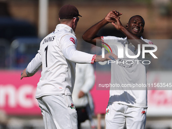 Anderson Phillip of Lancashire celebrates with Keaton Jennings after trapping Alex Lees of Durham LBW during the Vitality County Championshi...