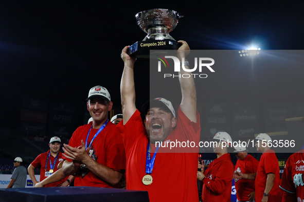 Othon Diaz lifts the Zaachila Cup after winning the 2024 Mexican Baseball League (LMB) King Series Championship at Estadio Mobil Super. Diab...