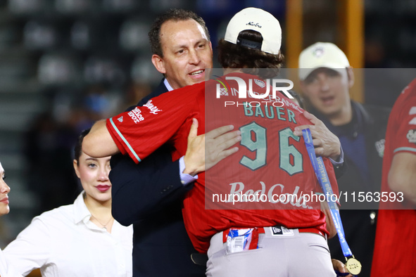 Trevor Bauer #96 of Diablos Rojos receives a gold medal from the president of LMB, Horacio de la Vega, after winning the 2024 Mexican Baseba...