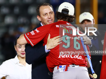 Trevor Bauer #96 of Diablos Rojos receives a gold medal from the president of LMB, Horacio de la Vega, after winning the 2024 Mexican Baseba...