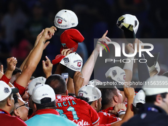 Diablos Rojos teammates celebrate after winning the 2024 Mexican Baseball League (LMB) King Series Championship at Estadio Mobil Super. Diab...