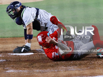 Juan Carlos Gamboa #47 of Diablos Rojos slides to home against Jonathan Morales #27 of Sultanes de Monterrey during the 2024 Mexican Basebal...