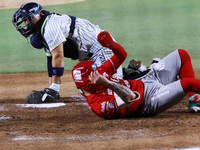 Juan Carlos Gamboa #47 of Diablos Rojos slides to home against Jonathan Morales #27 of Sultanes de Monterrey during the 2024 Mexican Basebal...