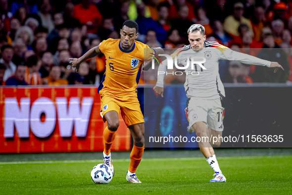 Netherlands midfielder Ryan Gravenberch and Germany midfielder Florian Wirtz during the match between the Netherlands and Germany at the Joh...