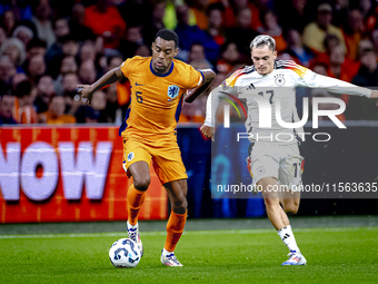 Netherlands midfielder Ryan Gravenberch and Germany midfielder Florian Wirtz during the match between the Netherlands and Germany at the Joh...