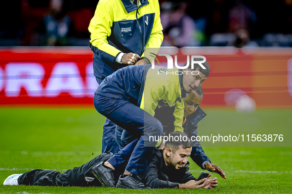 A supporter is on the pitch during the match between the Netherlands and Germany at the Johan Cruijff ArenA for the UEFA Nations League, Lea...