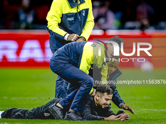 A supporter is on the pitch during the match between the Netherlands and Germany at the Johan Cruijff ArenA for the UEFA Nations League, Lea...