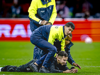 A supporter is on the pitch during the match between the Netherlands and Germany at the Johan Cruijff ArenA for the UEFA Nations League, Lea...