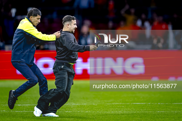 A supporter is on the pitch during the match between the Netherlands and Germany at the Johan Cruijff ArenA for the UEFA Nations League, Lea...