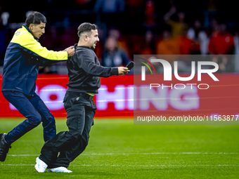 A supporter is on the pitch during the match between the Netherlands and Germany at the Johan Cruijff ArenA for the UEFA Nations League, Lea...