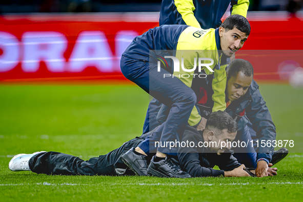 A supporter is on the pitch during the match between the Netherlands and Germany at the Johan Cruijff ArenA for the UEFA Nations League, Lea...