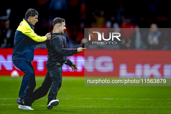 A supporter is on the pitch during the match between the Netherlands and Germany at the Johan Cruijff ArenA for the UEFA Nations League, Lea...