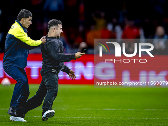 A supporter is on the pitch during the match between the Netherlands and Germany at the Johan Cruijff ArenA for the UEFA Nations League, Lea...