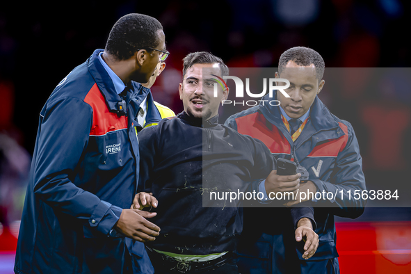 A supporter is on the pitch during the match between the Netherlands and Germany at the Johan Cruijff ArenA for the UEFA Nations League, Lea...