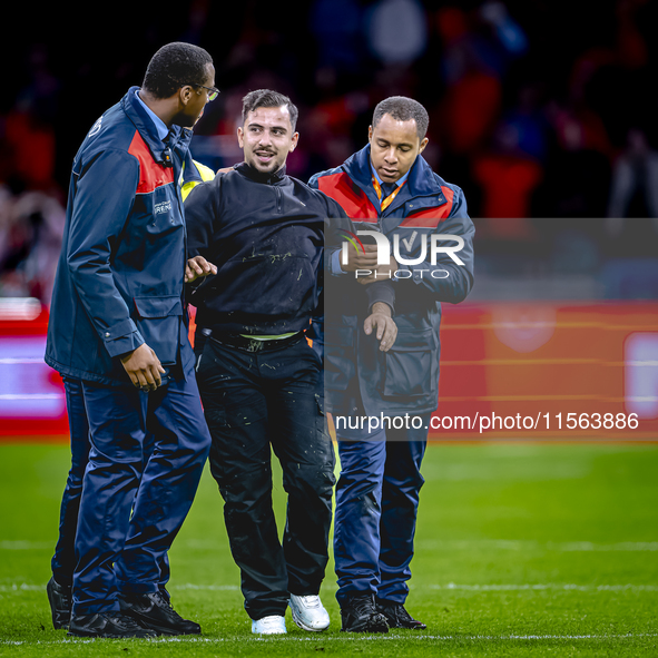 A supporter is on the pitch during the match between the Netherlands and Germany at the Johan Cruijff ArenA for the UEFA Nations League, Lea...