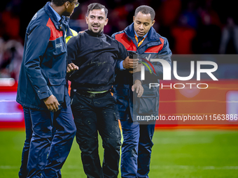 A supporter is on the pitch during the match between the Netherlands and Germany at the Johan Cruijff ArenA for the UEFA Nations League, Lea...