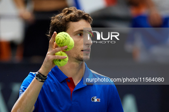 Ugo Humbert of France holds three tennis balls following the game against Alexei Popyrin of Australia during the Davis Cup Group B Stage 202...