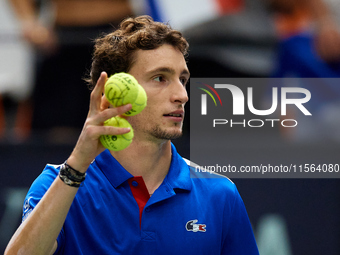 Ugo Humbert of France holds three tennis balls following the game against Alexei Popyrin of Australia during the Davis Cup Group B Stage 202...