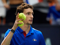 Ugo Humbert of France holds three tennis balls following the game against Alexei Popyrin of Australia during the Davis Cup Group B Stage 202...