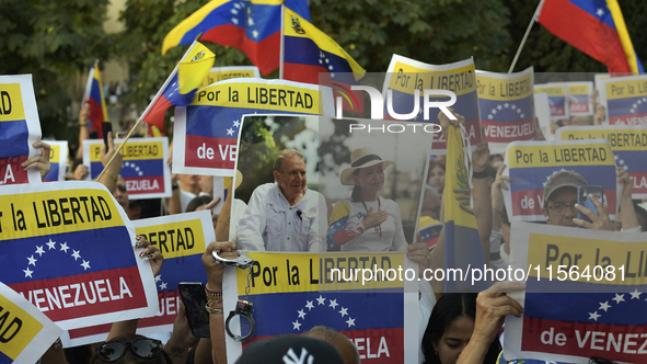 A person holds a picture of Venezuelan opposition presidential candidate Edmundo Gonzalez and Venezuela's opposition leader Maria Corina Mac...