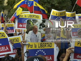 A person holds a picture of Venezuelan opposition presidential candidate Edmundo Gonzalez and Venezuela's opposition leader Maria Corina Mac...