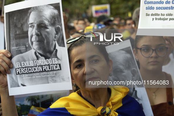 Venezuelans living in Spain take part in a gathering outside the Spanish parliament in support of opposition presidential candidate Edmundo...